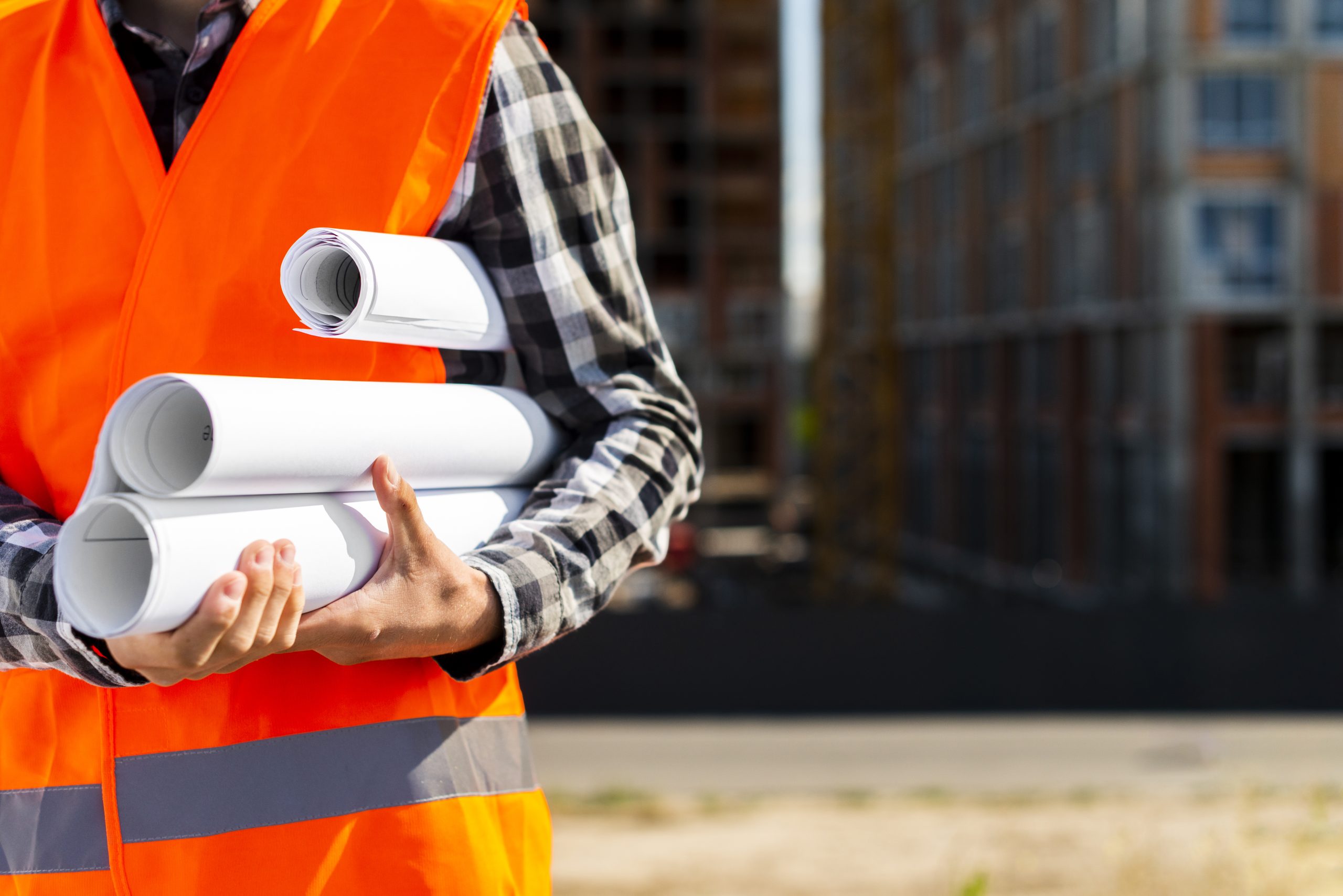 close-up-construction-engineer-holding-plans-hands